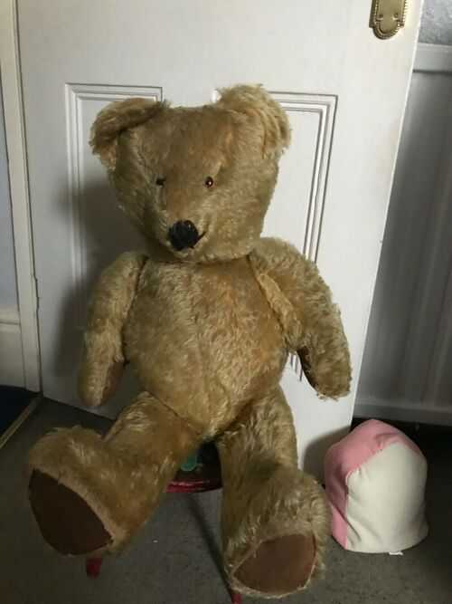 Antique very large straw filled teddybear all hoibted