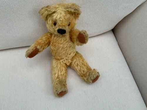 Vintage teddy bear with jointed limbs.