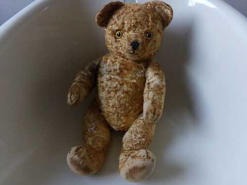 antique teddy bear, well worn, jointed arms/legs, bald patches, bit stiff, straw